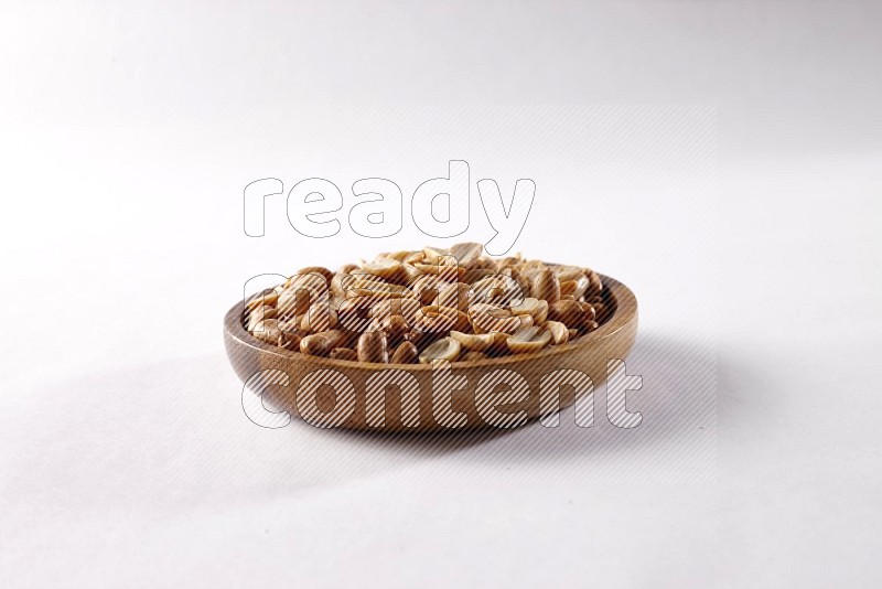 Peanuts in a wooden bowl on white background