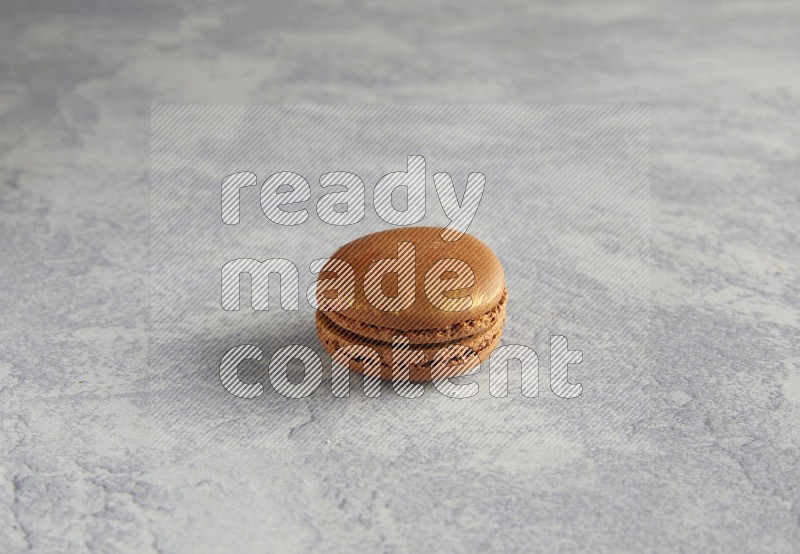 45º Shot of Brown Coffee macaron on white  marble background