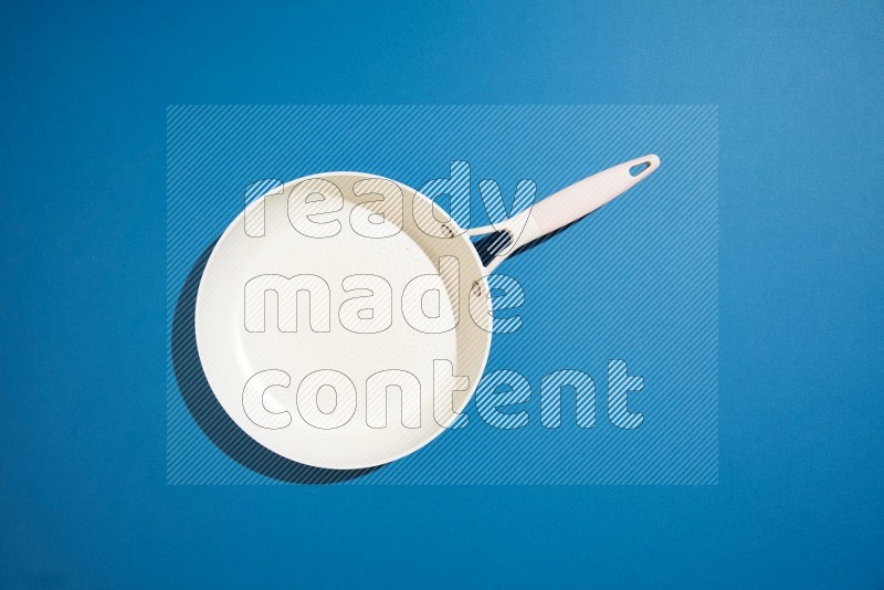 white pan on blue background