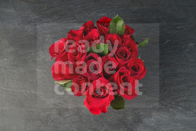 A luxurious bouquet of red roses on black marble background