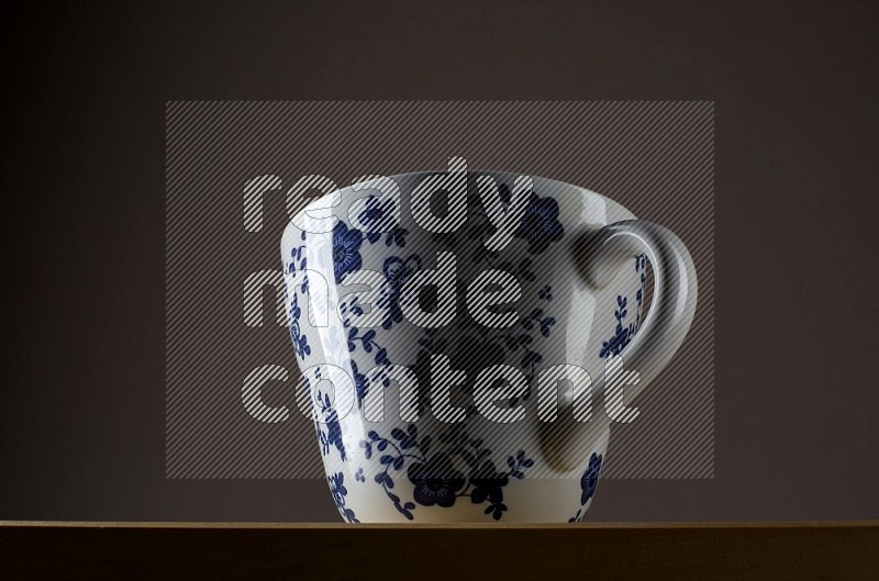 Low angle shot of a decorated cup on grey background