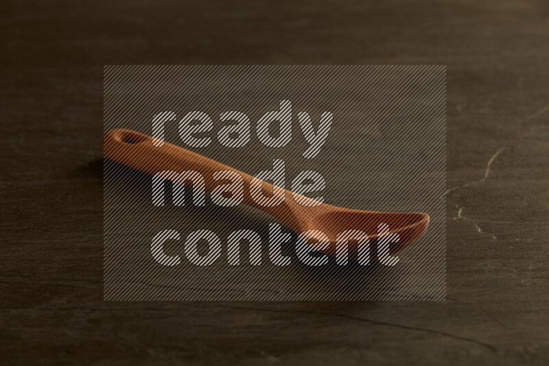 wooden spoon on black slate background