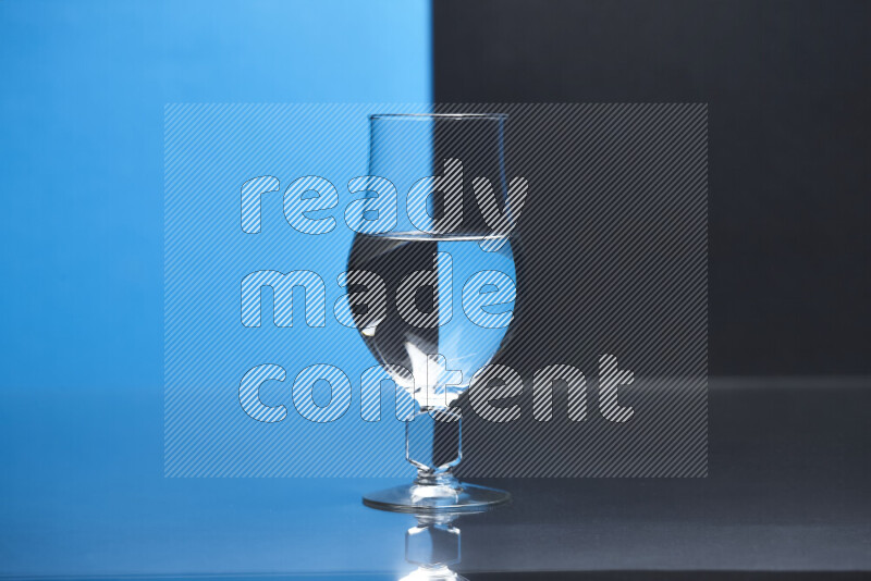 The image features a clear glassware filled with water, set against blue and black background