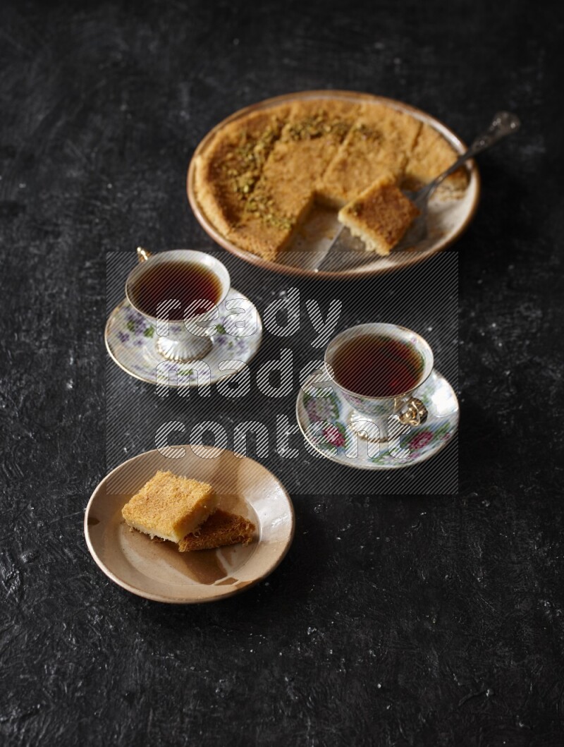 konafa with tea in a dark setup