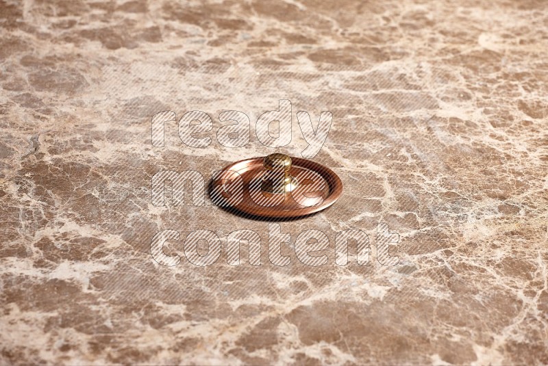 Small Copper Pot's Lid on Beige Marble Flooring