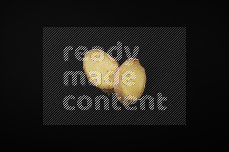 Fresh ginger slices on black background