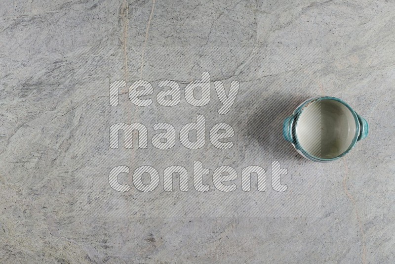 Top View Shot Of A Multicolored Pottery Bowl On Grey Marble Flooring