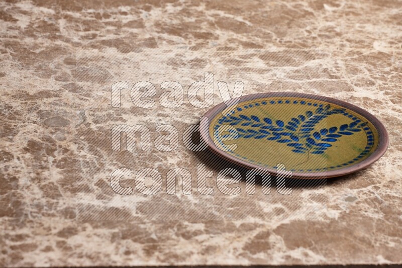 Decorative Pottery Plate on Beige Marble Flooring
