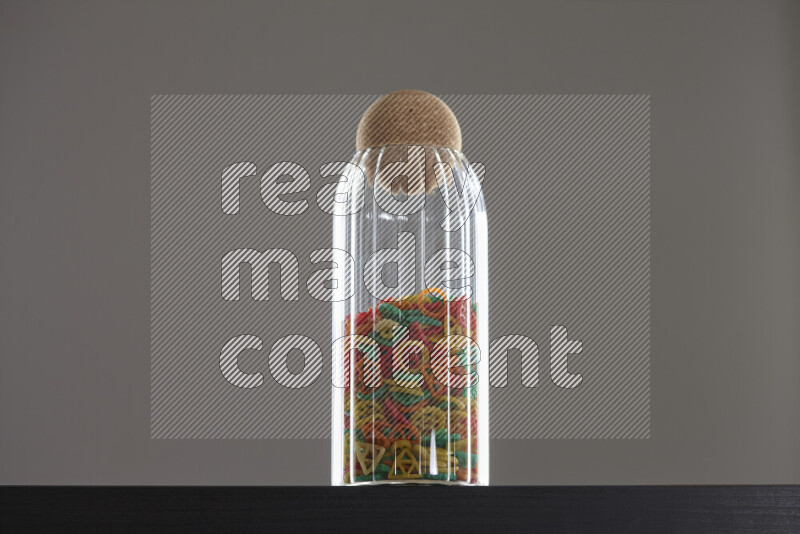 Snacks in a glass jar on black background