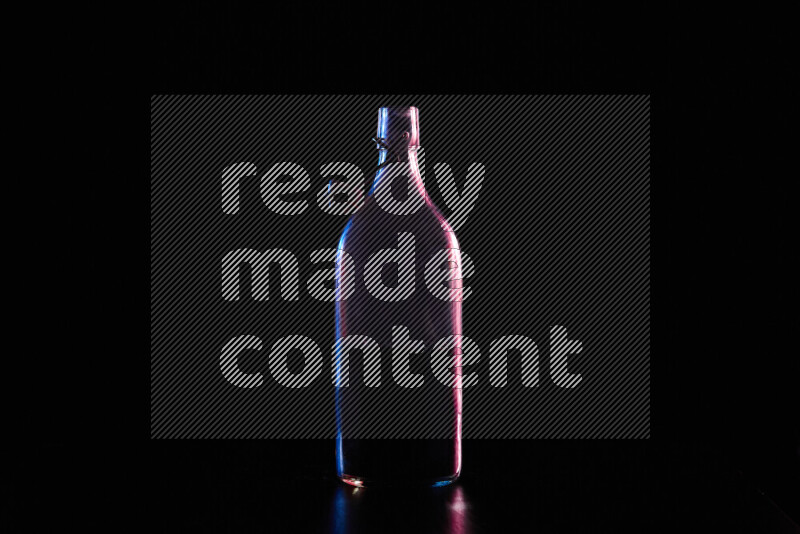 Water bottle with colored rim light against black background