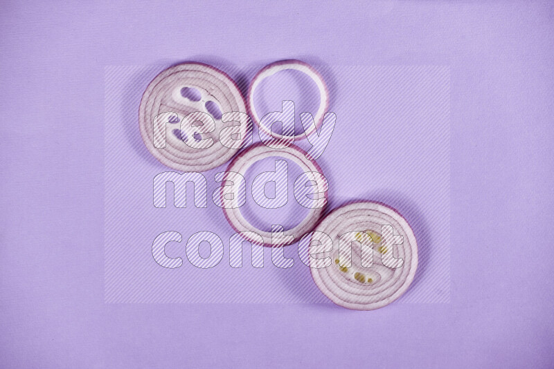 Red onions rings on purple background