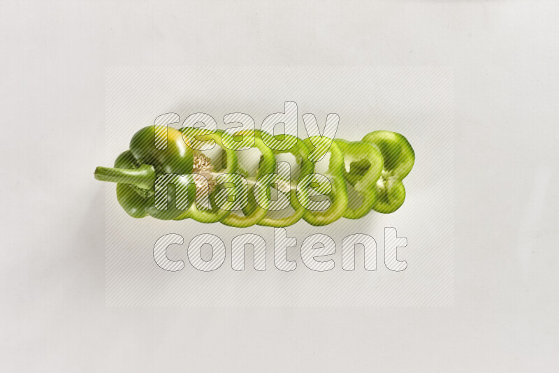 Green bell pepper slices on white background