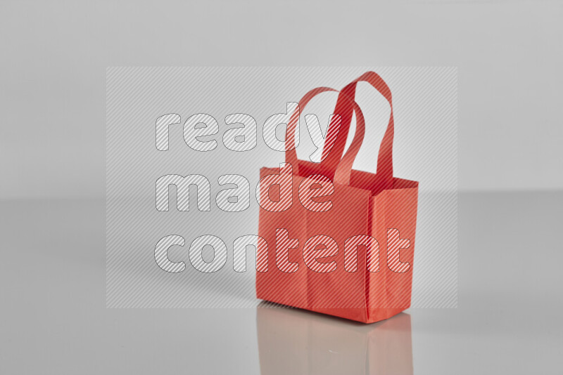 Origami shopping bag on grey background