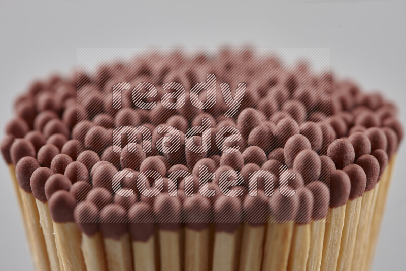 A close-up of a bundle of matches on grey background