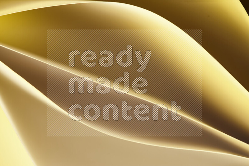 This image showcases an abstract paper art composition with paper curves in gold gradients created by colored light