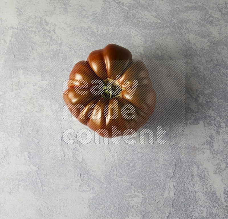 Single Topview Heirloom Tomato on a sky blue background