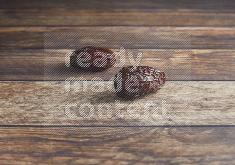 two madjoul dates on a wooden background