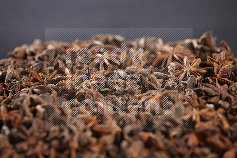 Star Anise fill the frame on black flooring