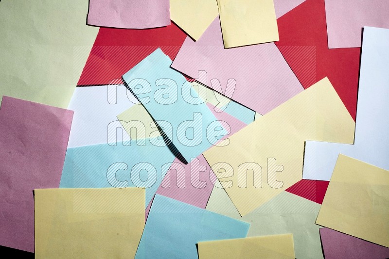 Multicolored paper sheet on black background