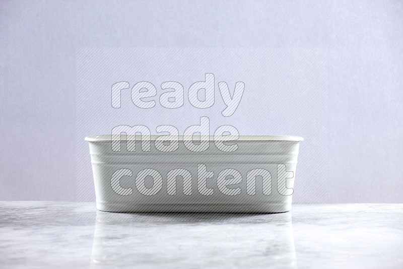 An Empty White Plant Pot on light grey Marble Flooring 15 degree angle