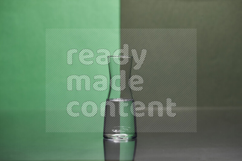 The image features a clear glassware filled with water, set against green and dark green background