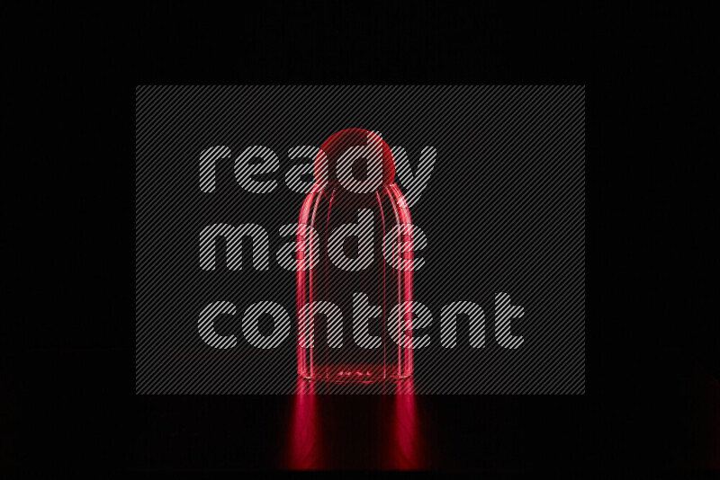 Glassware with rim light in red against black background