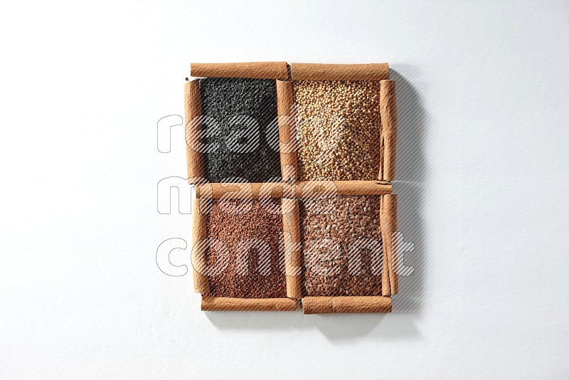 4 squares of cinnamon sticks full of black seeds, mustard seeds, flaxseeds and garden cress on white flooring