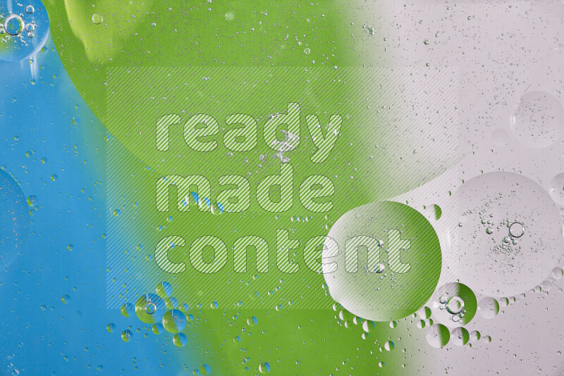 Close-ups of abstract oil bubbles on water surface in shades of white, green and blue