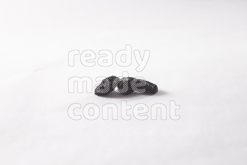 Dried plums on white background