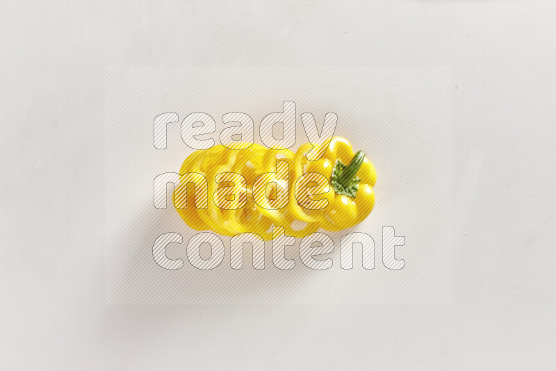 Yellow bell pepper slices on white background