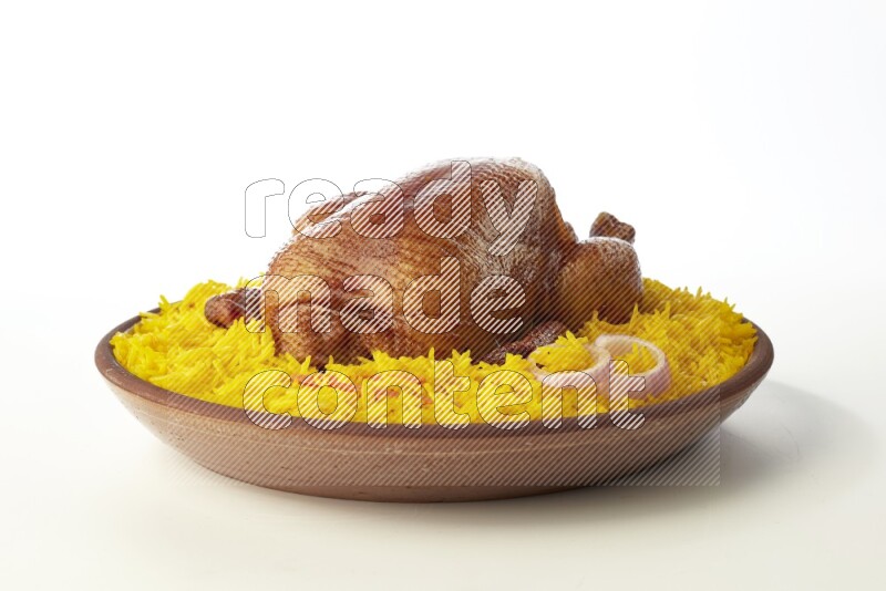 yellow basmati Rice with whole roasted chicken  on a pottery plate  direct  on white background