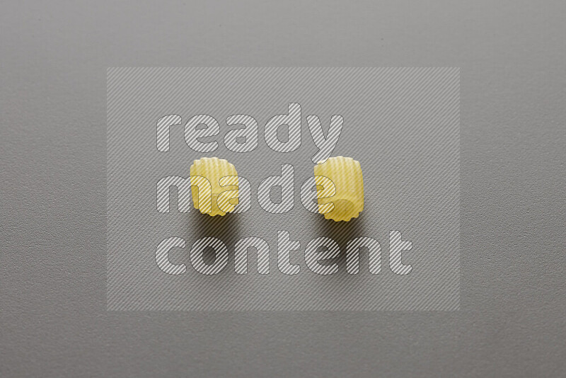 Small rings pasta on grey background