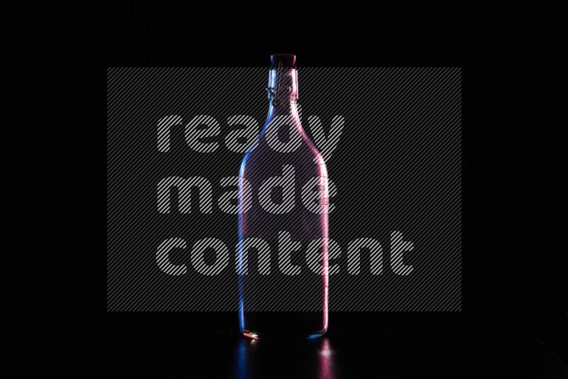 Water bottle with colored rim light against black background