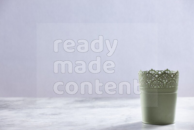 An empty green plant pot on grey marble background