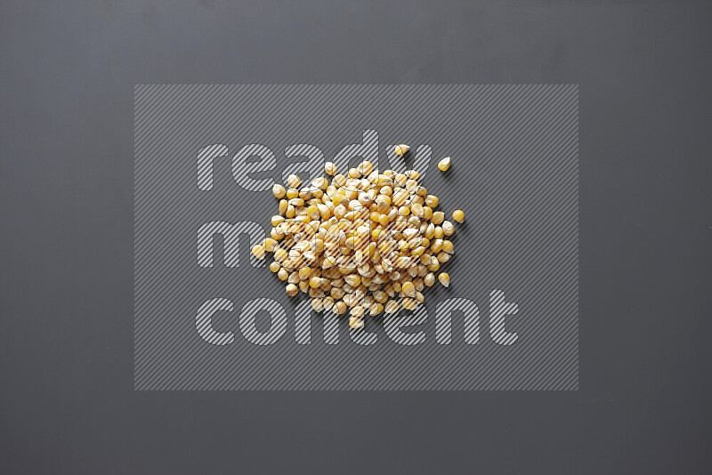 Dry corn kernels on grey background