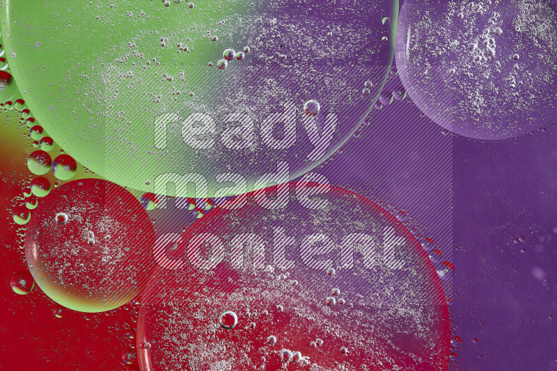 Close-ups of abstract oil bubbles on water surface in shades of purple, green and red