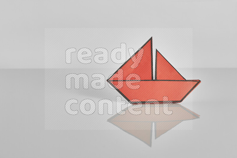 Origami boat on grey background