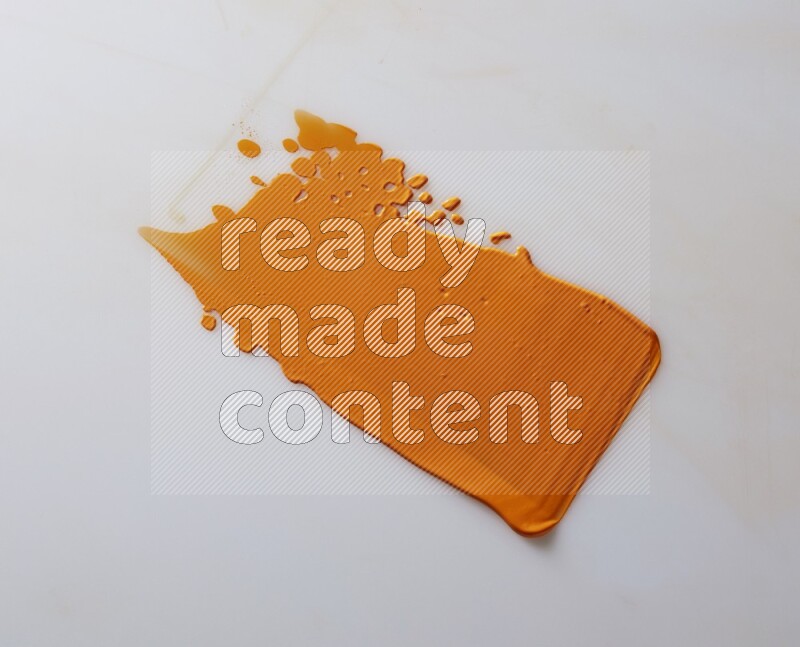 An orange straight painting knife stroke on white background