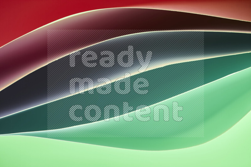 This image showcases an abstract paper art composition with paper curves in green and red gradients created by colored light
