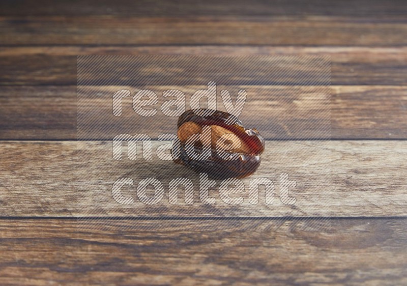 almond stuffed madjoul date on a wooden background