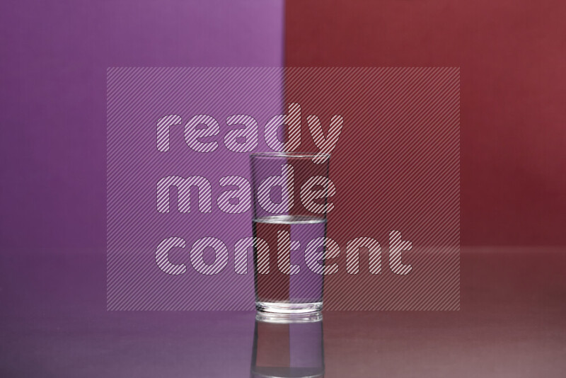 The image features a clear glassware filled with water, set against purple and dark red background