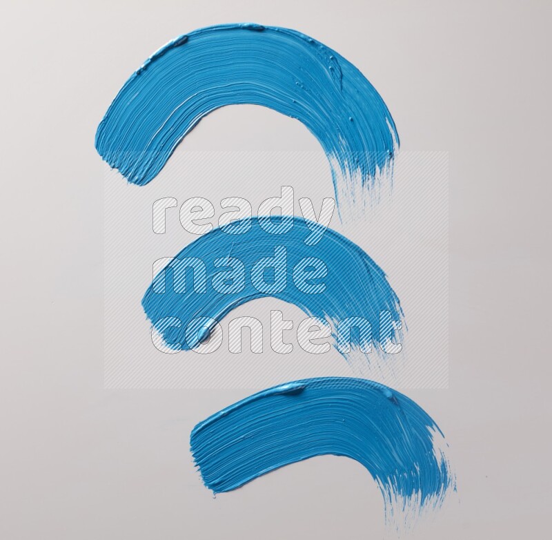 Multi blue curved brush strokes shaped into different shapes on a white background