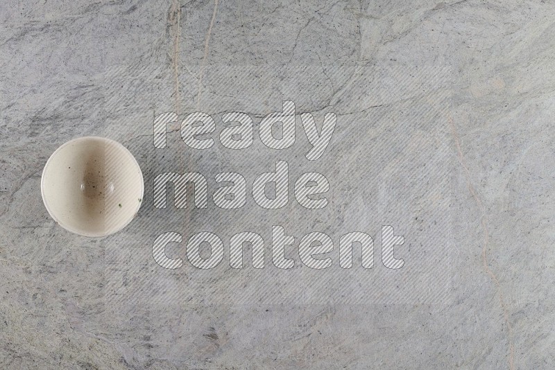 Top View Shot Of A White Pottery Bowl On Grey Marble Flooring