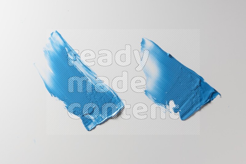Blue painting knife strokes on white background
