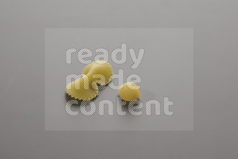 Fiocchi pasta with other types of pasta on grey background