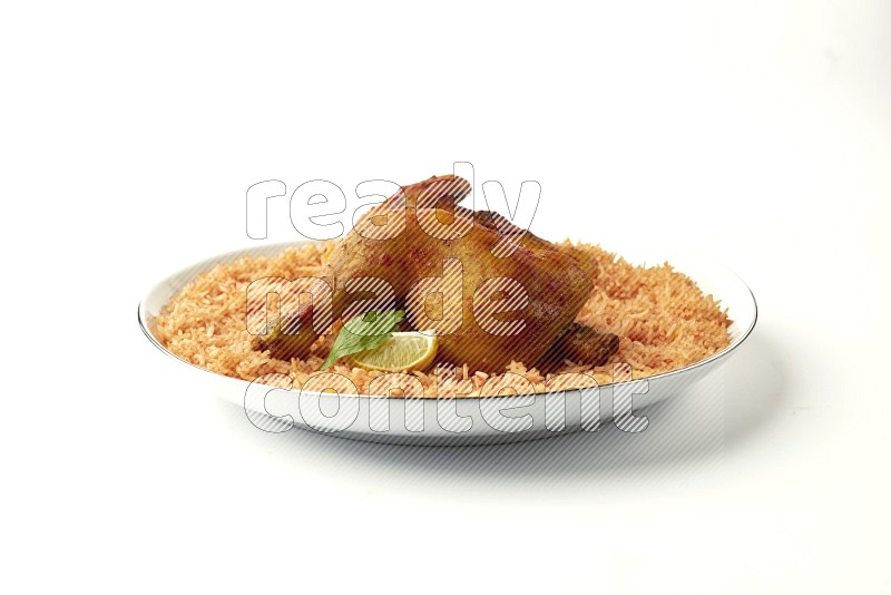 red basmati Rice with  kabsa chicken pieces on a white plate with a silver rim direct  on white background