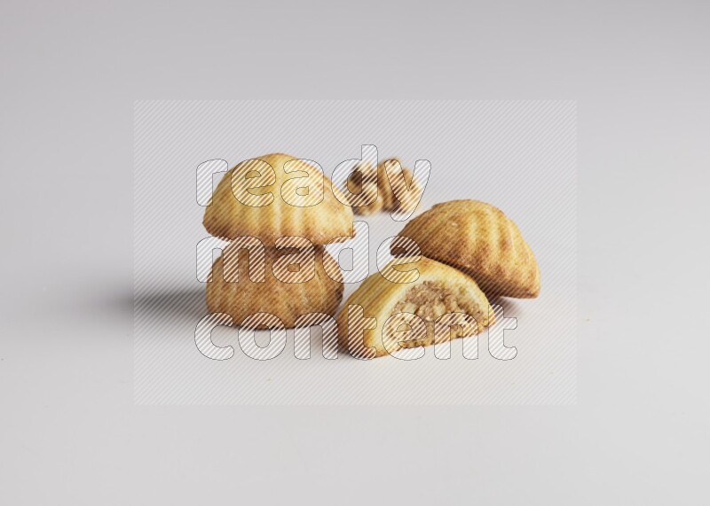Four Pieces of Maamoul filled with walnut paste  one of them is cut direct on white background