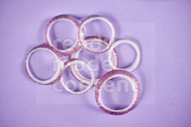 Red onions rings on purple background