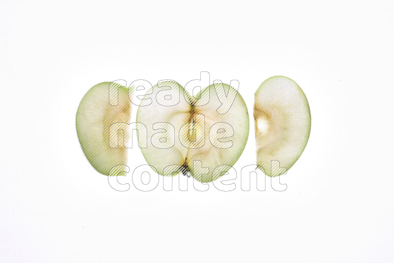 Apple slices on illuminated white background