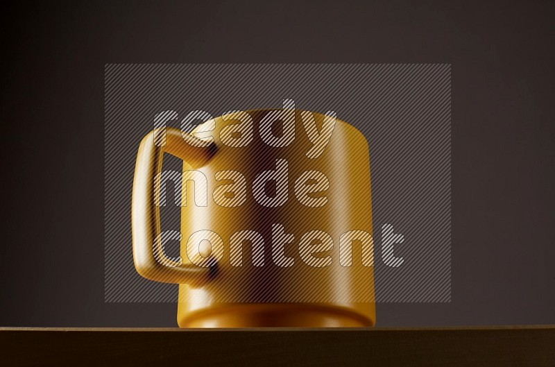 Low angle shot of a yellow cup on grey background